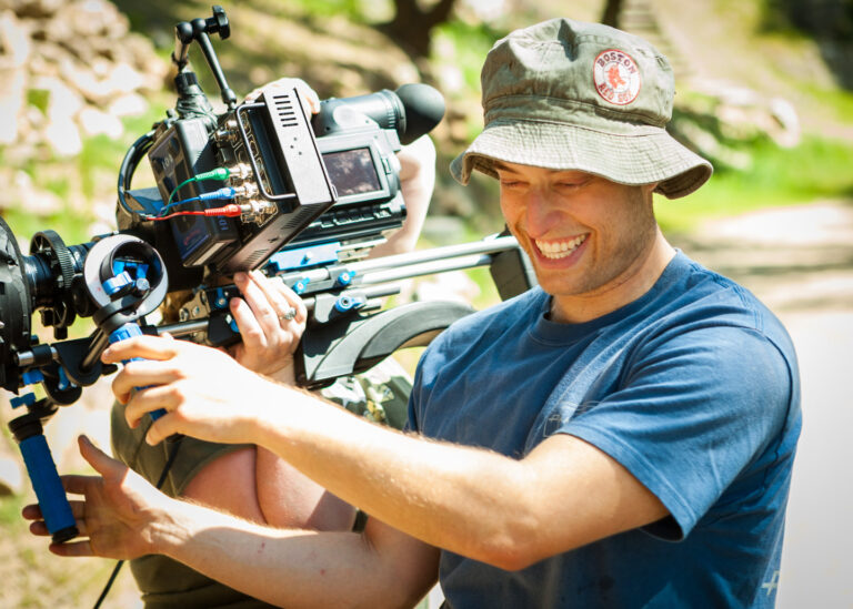 Behind the scenes of Act Naturally Cinematographer Dustin Pearlman smiling while operating HVX-200 with Letus35 Adaptor