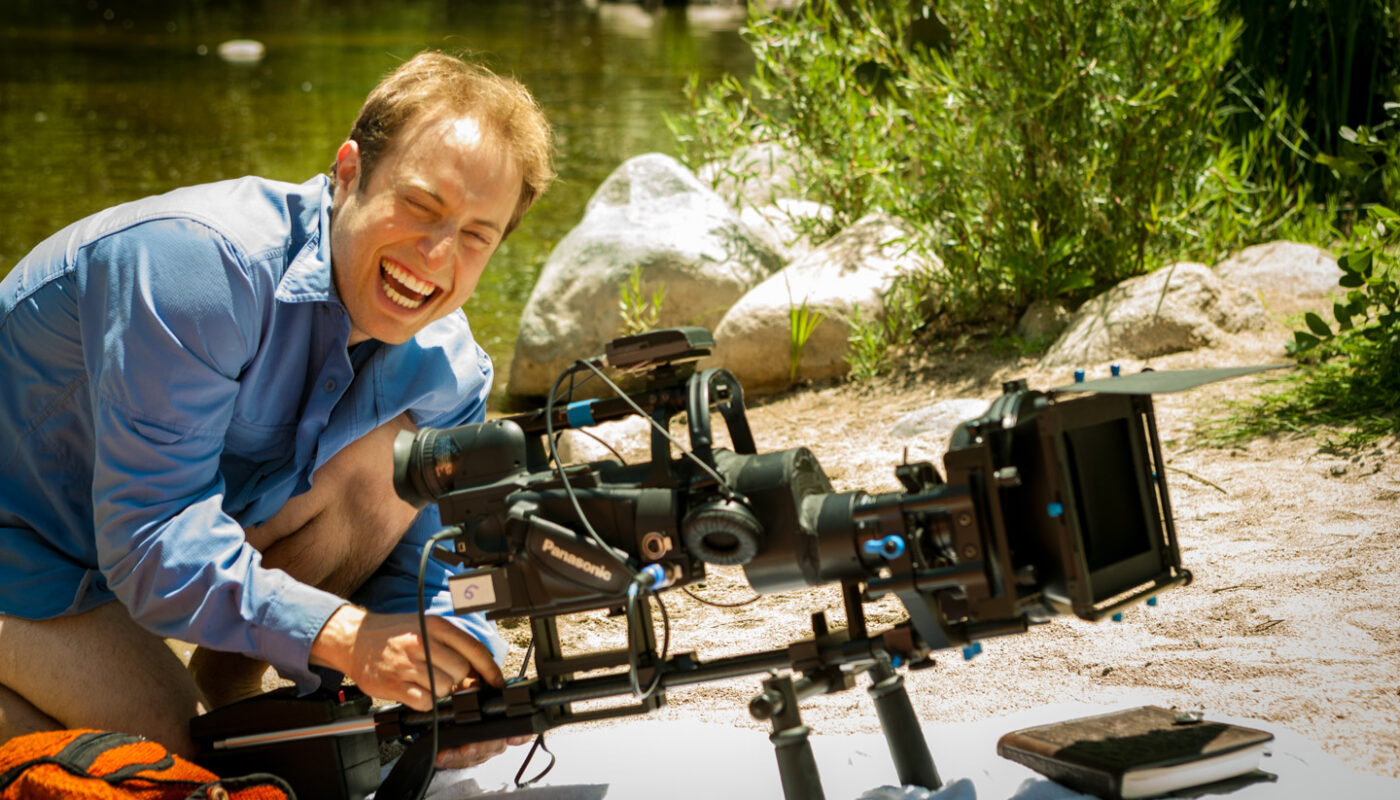 Behind the scenes of Act Naturally Cinematographer Dustin Pearlman smiling while operating HVX-200 with Letus35 Adaptor