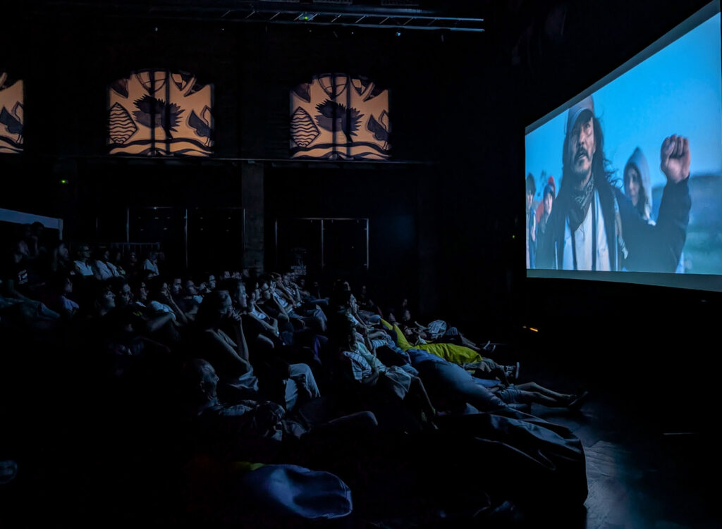 A full theater watching Illegal Aliens on the big screen