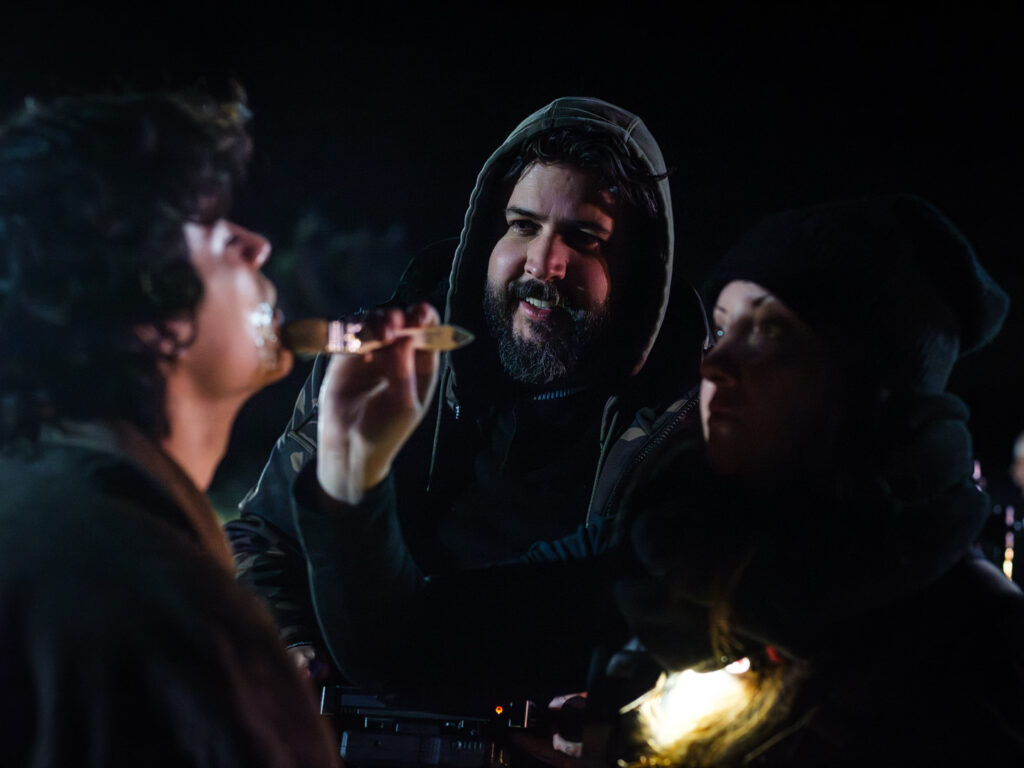 From the set of Illegal Aliens, Dalton watches SFX Make Up applied to Kevin