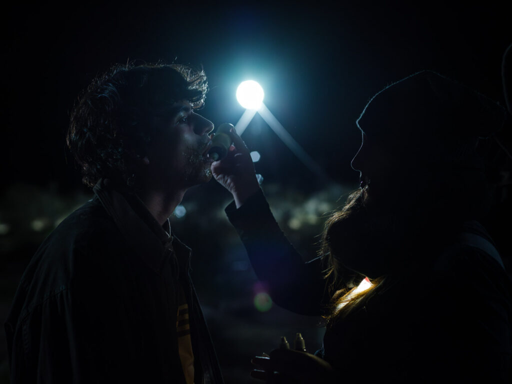 From the set of Illegal Aliens, Sierra Spence applies makeup to Kevin Corte