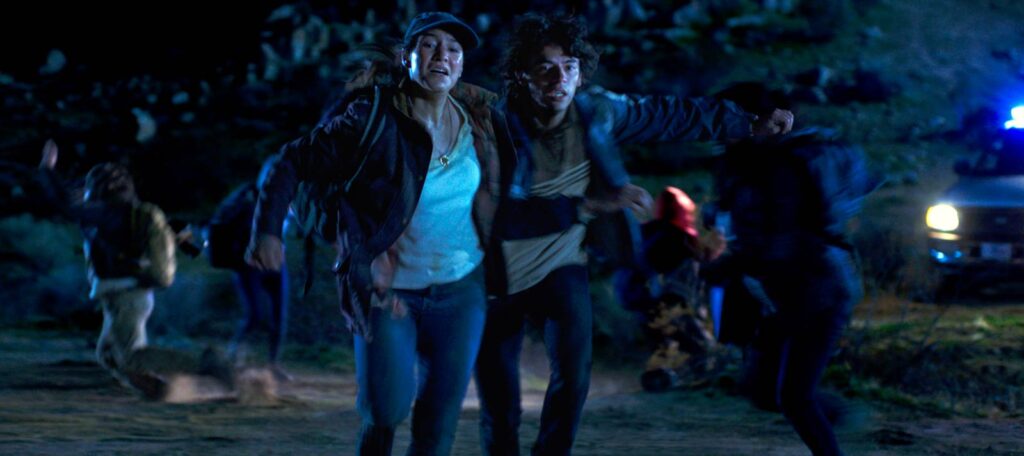 Frame grab from Illegal Aliens of migrants running from a Border Patrol vehicle
